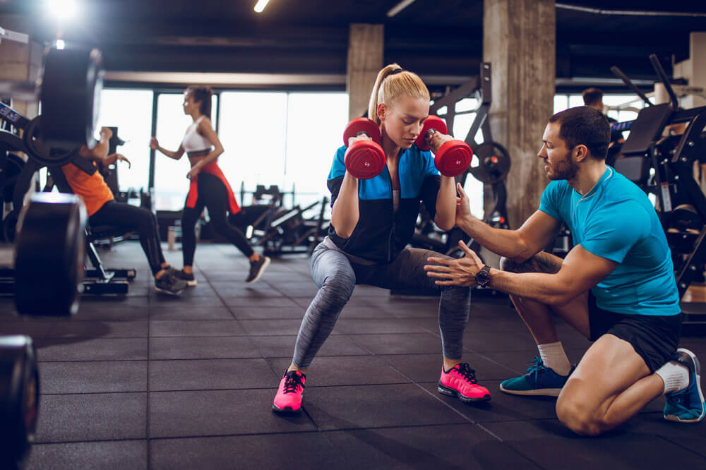 A girl at gym with his trainer