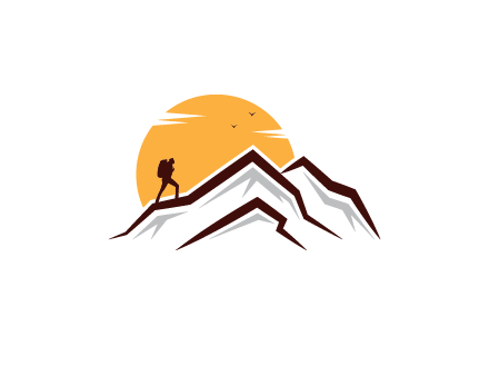 sun behind hiker on mountain